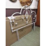 A 4'6" boxed white metalwork headboard