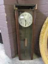 An early 20th century oak cased electric drop dial wall clock