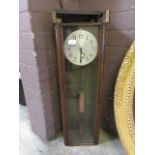An early 20th century oak cased electric drop dial wall clock
