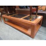 A modern oak effect coffee table with three glass panel to top and under tier