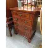 A reproduction flame mahogany cabinet