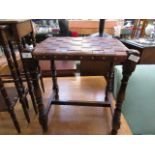 An early 20th century beech stool having a leather webbed seat