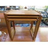 A nest of three mid-20th century teak occasional tables