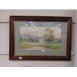 A framed and glazed watercolour of countryside scene