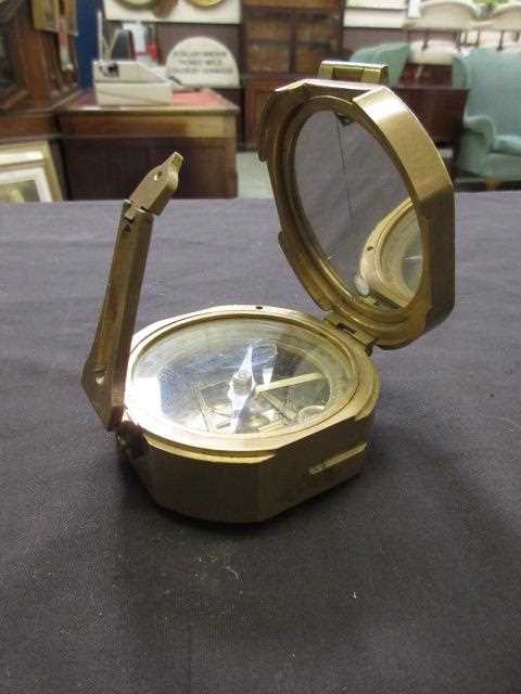 A brass cased Stanley compass with a selection of ephemera