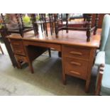 A mid-20th century oak twin pedestal desk