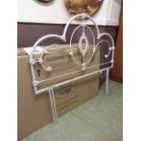 A 4'6" boxed white metalwork headboard