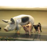 Three moulded figurines of pigs