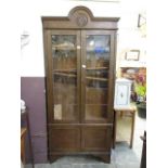 An early 20th century leaded glazed two door oak bookcase