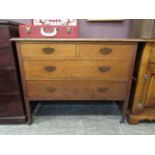 An early 20th century oak chest of two short over two long drawers