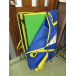 A blue bag containing green and yellow display boards