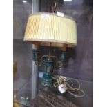 A green and gilt decorated ceramic table lamp with shade