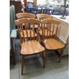 A set of four modern pine spindle back chairs