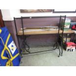 Two black clothes rails together with a selection of other metal rails