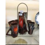 A brown glazed water jug and cup set