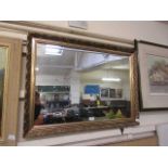 An ornate gilt framed rectangular mirror