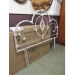 A 4'6" boxed white metalwork headboard