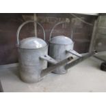 Two galvanized watering cans