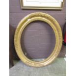 An ornate oval gilt frameMeasurements: - Front aperture; H: 73cm W: 61cm- Recess of frame; H: 77cm