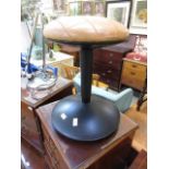 An IKEA mid-20th century style 'Vitamin' black PVC stool with tan leather upholstered seat