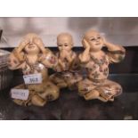 Three moulded models or oriental children 'Hear No Evil, Speak No Evil, See No Evil'