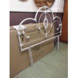 A 4'6" boxed white metalwork headboard