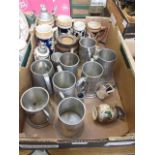 A tray containing metalware tankards, German steins etc.