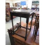 An early 20th century oak occasional table with barley twist supports