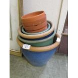 A collection of terracotta pots, some of which glazed