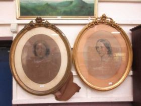 A pair of ornate gilt framed oval enhanced prints of ladies