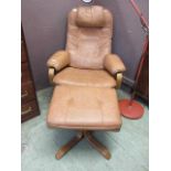 A modern tan leather swivel reclining chair with matching stool