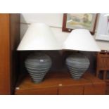 A pair of substantial grey ceramic table lamps with shades