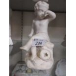 A white ceramic moulded model of cherub