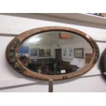 A gilt painted oval bevel glass mirror