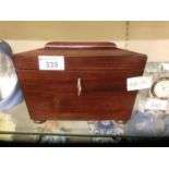 A regency mahogany sarcophagus tea caddy with two compartments on squat bun feet with key