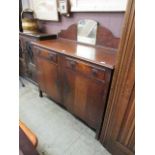 A mid-20th century oak sideboard having two drawers above cupboard doors