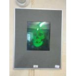 A framed green hologram of skull