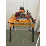 A Triton router table along with a Triton router and accessories