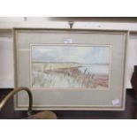 A framed and glazed watercolour of estuary scene signed bottom left