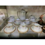 A selection of Limoges ceramic ware to include gilt rimmed cups and saucers and white metal rimmed