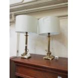 A pair of reproduction gilt metal columned table lamps