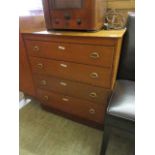 A mid-20th century oak veneered chest of four long drawers