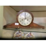 An oak cased mantle clock