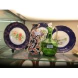 An oriental style vase along with a green glass water jug and three Wood and Sons plates