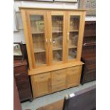 A modern oak glazed bookcase, the top section having three glazed doors, the bottom having three