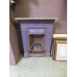 A cast iron Victorian fireplace painted purple