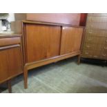 A mid-20th century teak sideboard with two sliding doors