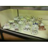 A large selection of ceramic cottages by Coalport