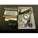 A box containing a pair of oriental style shoes, glasses, pens, etc