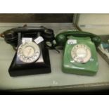 A black Bakelite telephone along with a green Bakelite telephone